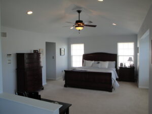 A bedroom featuring recessed lighting and a ceiling fan installed by Conductive Electrical Contracting in Smyrna, DE.