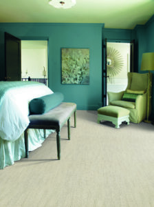 A cozy bedroom featuring a new textured carpet installation by West Michigan Flooring & Interiors in Grand Rapids, MI.