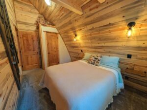 A cozy bedroom featuring wall-mounted light fixtures installed by BlackRock Electrical in Pocatello, ID.