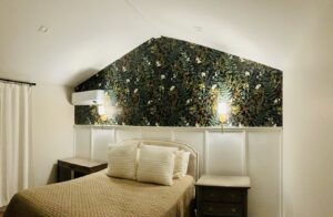 Bedroom with newly installed wall sconces and a mini-split AC unit by AVA Electric, LLC in Fort Worth, TX.