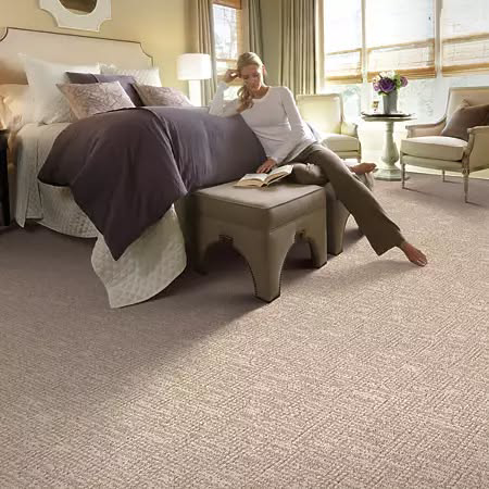 A comfortable bedroom featuring new wall-to-wall carpet installed by Levi's 4 Floors in Columbus, OH