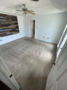 A bedroom with a clean carpet and ceiling fan after service by Alamogordo Carpet Cleaning in Alamogordo, NM.