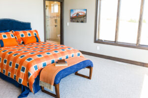A cozy bedroom featuring freshly laid light-colored carpet by Floors & More Abbey Flooring in Great Falls, MT.