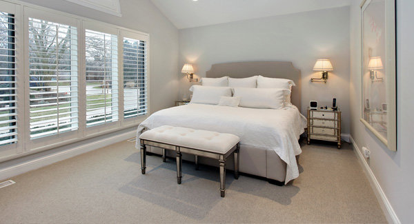 A clean bedroom featuring light-colored wall-to-wall carpet, installed by Duke Brothers Oriental Rug Cleaning in Norfolk, VA.
