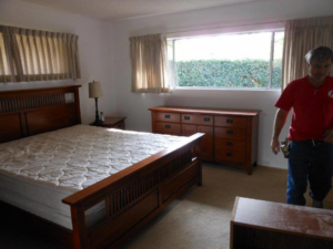 A cozy bedroom featuring newly installed light-colored carpet by Underwood Floor Covering in San Diego, CA.