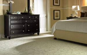 A beautifully decorated bedroom featuring a light-colored patterned carpet from ProSource Flooring Kitchen & Bath of Naperville, IL.