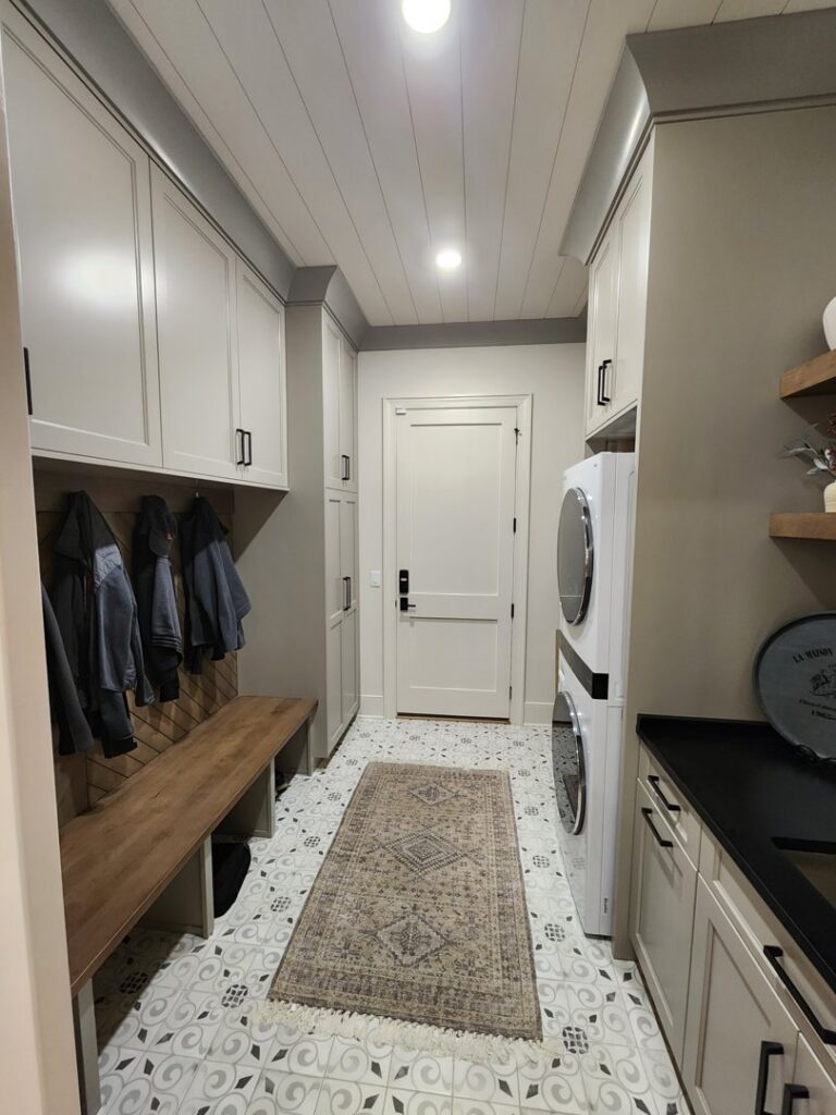 A bedroom showcasing new grey carpet installation and a modern bed frame by Dalton Wholesale in Adairsville, GA.