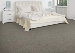 A bedroom featuring newly installed gray carpet by Carpet Warehouse and Color Tile in Coeur d'Alene, ID.