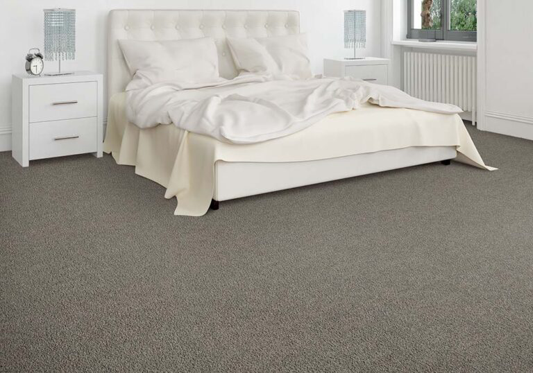 A bedroom featuring newly installed gray carpet by Carpet Warehouse and Color Tile in Coeur d'Alene, ID.