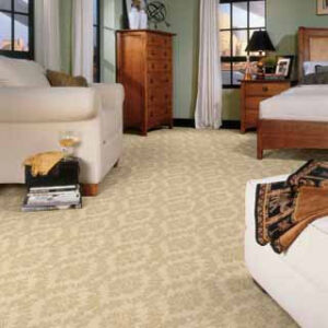 A cozy bedroom showcasing newly installed patterned beige carpet by McClincy's in Renton, WA.