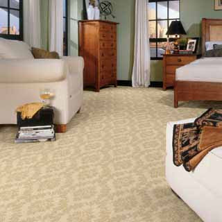 A cozy bedroom showcasing newly installed patterned beige carpet by McClincy's in Renton, WA.
