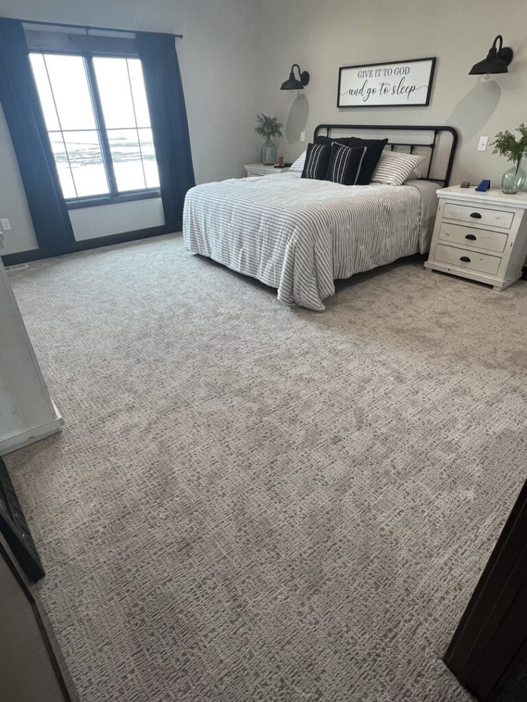 A modern bedroom featuring a stylish patterned carpet installation by Mozak's Floors & More in Yankton, SD