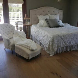 Newly installed light wood flooring in a bedroom by Carpets By Cal Inc in Vernal, UT