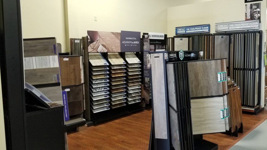 Before and after view of a living room with new light-colored carpet installed by FloorMax in Silver Spring, MD.