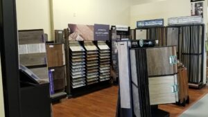 Before and after view of a living room with new light-colored carpet installed by FloorMax in Silver Spring, MD.