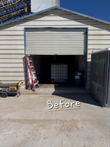 A 'Before' photo showing a damaged or partially open roll-up garage door on a metal building, ready for service by Atomic Door Service in Tulsa, OK.
