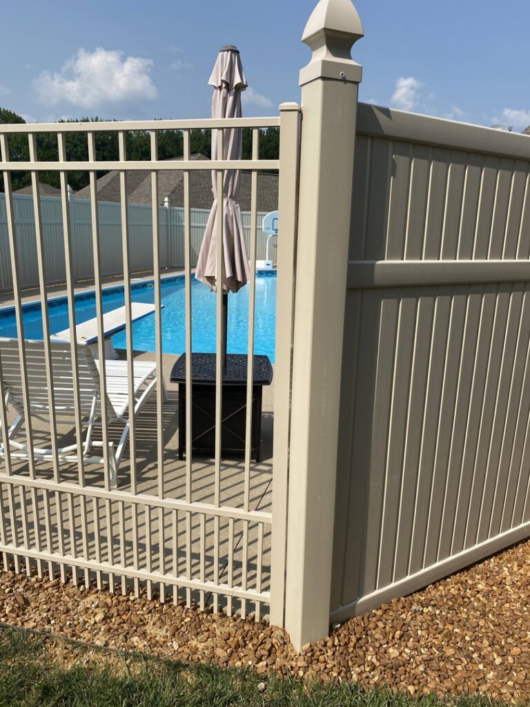 A beige aluminum fence with a gate installed around a swimming pool by ACE and Sons Fence Company in Evansville, IN.