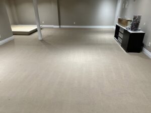 Clean beige carpet with fresh vacuum lines in a basement, serviced by PROlific Cleaning Services LLC in Indianapolis, IN.