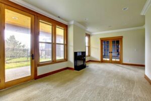 A room with newly installed beige carpet and large windows, completed by Big Orange Country Carpets & Concepts in Knoxville, TN.