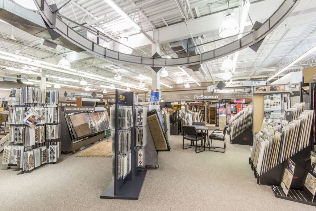 Beige and brown carpet samples on a display rack at Prosource of Erie, showcasing options in Erie, PA.