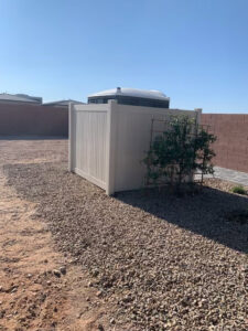 A section of beige vinyl privacy fence installed in a backyard by Hirschi Iron in North Las Vegas, NV.
