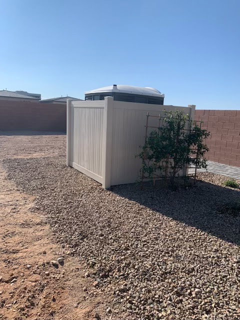 A section of beige vinyl privacy fence installed in a backyard by Hirschi Iron in North Las Vegas, NV.