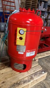 A red Bell & Gossett HVAC pressure tank with an air pressure gauge at Thermoflo Equipment in Pittsburgh, PA