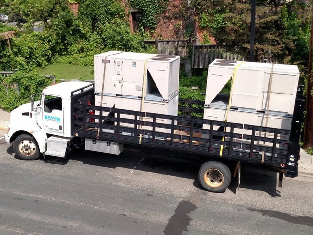 Benck Mechanical Inc truck transporting large commercial HVAC units for a job in Somerset, WI.