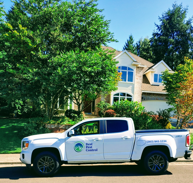 A Best Pest Control truck parked at a residential home in Beaverton, OR, indicating a pest control service job.
