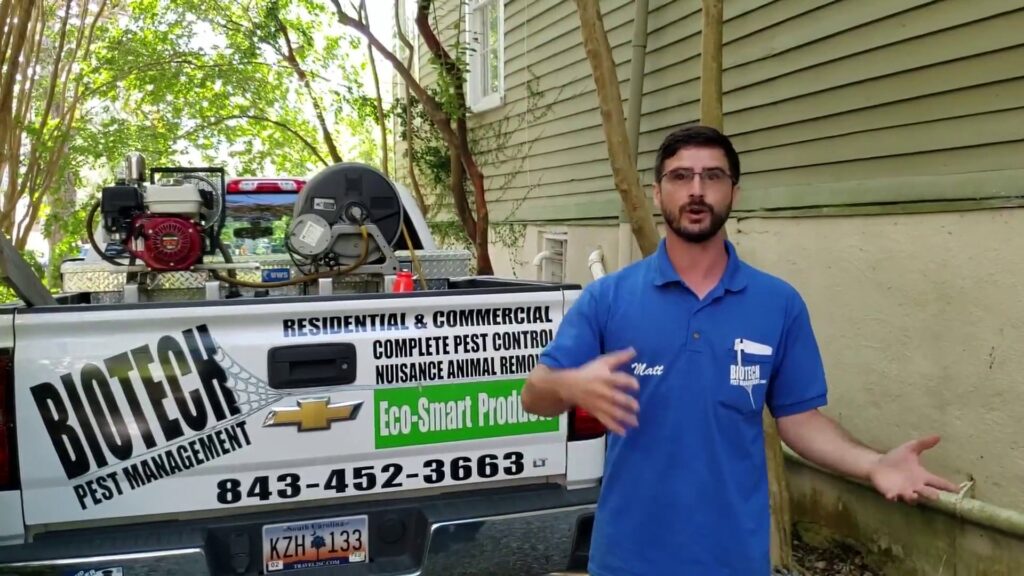 A Biotech Pest Management technician, Matt, standing by a company truck with pest control equipment in Summerville, SC.