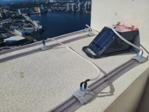A bird deterrent system installed on a rooftop by Xceptional Wildlife Removal Jacksonville, FL, overlooking the city.