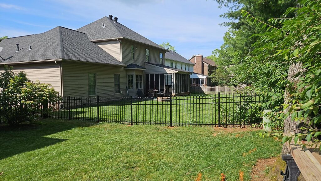 A black aluminum fence enclosing a residential backyard installed by Border Built Fencing in Florence, KY.
