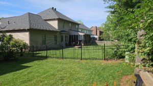 A black aluminum fence enclosing a residential backyard installed by Border Built Fencing in Florence, KY.