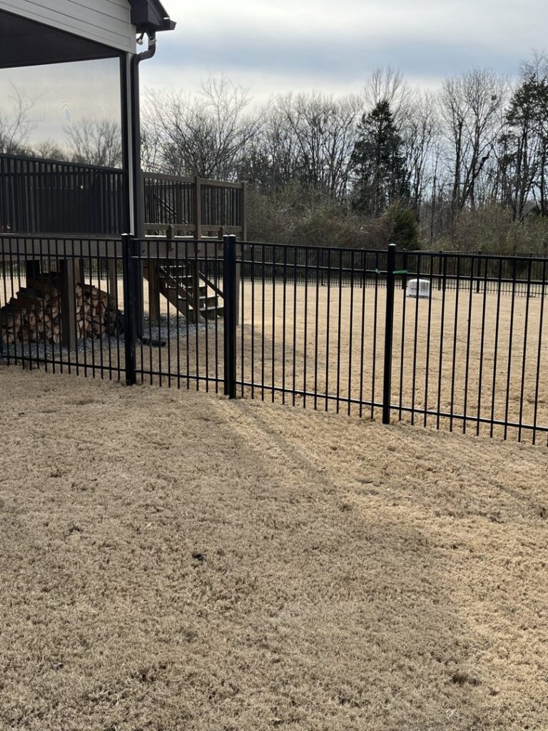 A black aluminum fence installed in a residential backyard by Fantastic Fences in Chattanooga, TN
