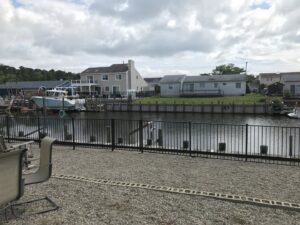 A black aluminum fence installed along a canal or waterway by MAC Fencing LLC in Toms River, NJ