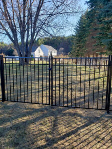 A black ornamental aluminum double gate providing secure access to a residential property by Sullivan & Sons Fence LLC in Hudson, NH.