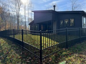 A stylish black aluminum fence installed around a modern house by ACE and Sons Fence Company in Evansville, IN.