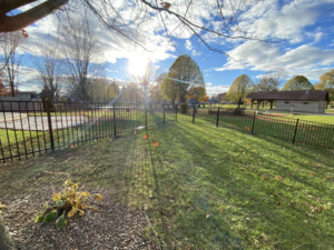 A new black ornamental aluminum fence installed around a park playground area by Safe Yard Fence - Waukesha County in Waukesha, WI.
