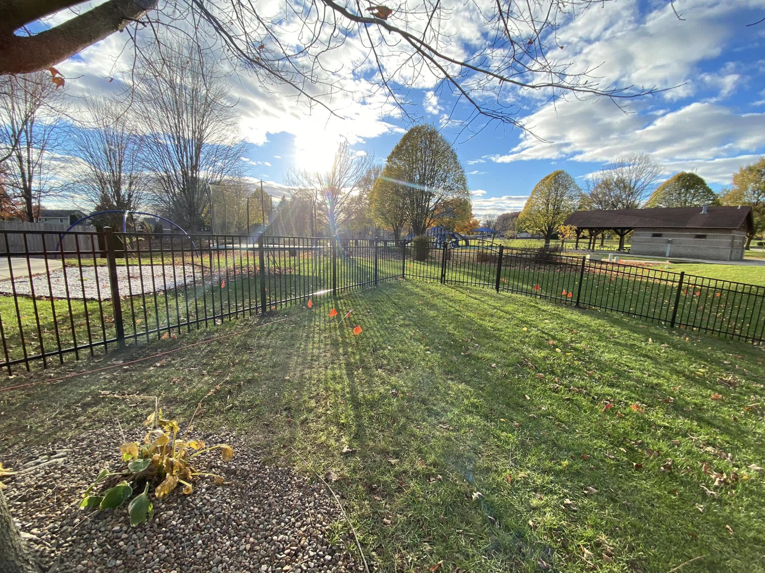 A new black ornamental aluminum fence installed around a park playground area by Safe Yard Fence - Waukesha County in Waukesha, WI.