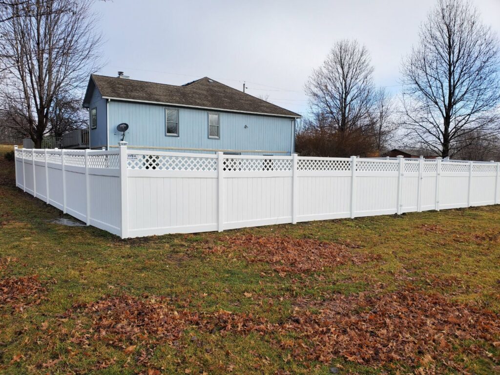 A black aluminum fence installed around a backyard playhouse by Royal Fence & Design LLC in Olathe, KS.