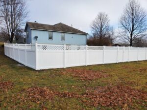 A black aluminum fence installed around a backyard playhouse by Royal Fence & Design LLC in Olathe, KS.