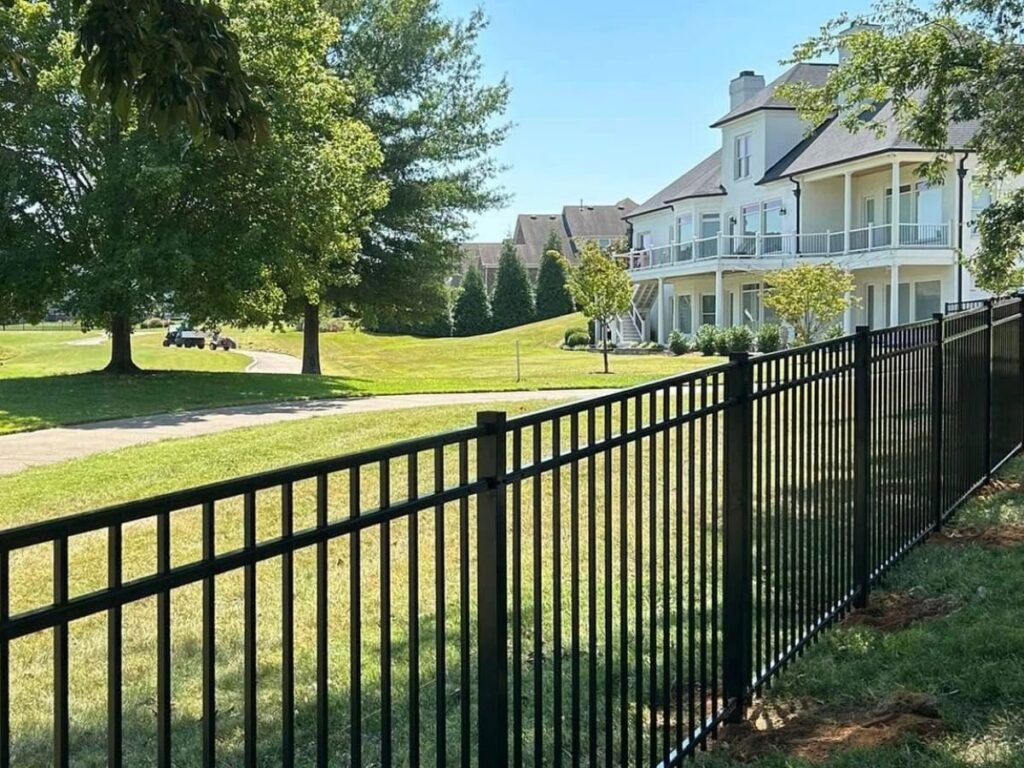 A sleek black aluminum fence installed along a residential property line by Frontier Fence LLC Bowling Green,Ky