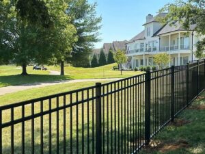 A sleek black aluminum fence installed along a residential property line by Frontier Fence LLC Bowling Green,Ky