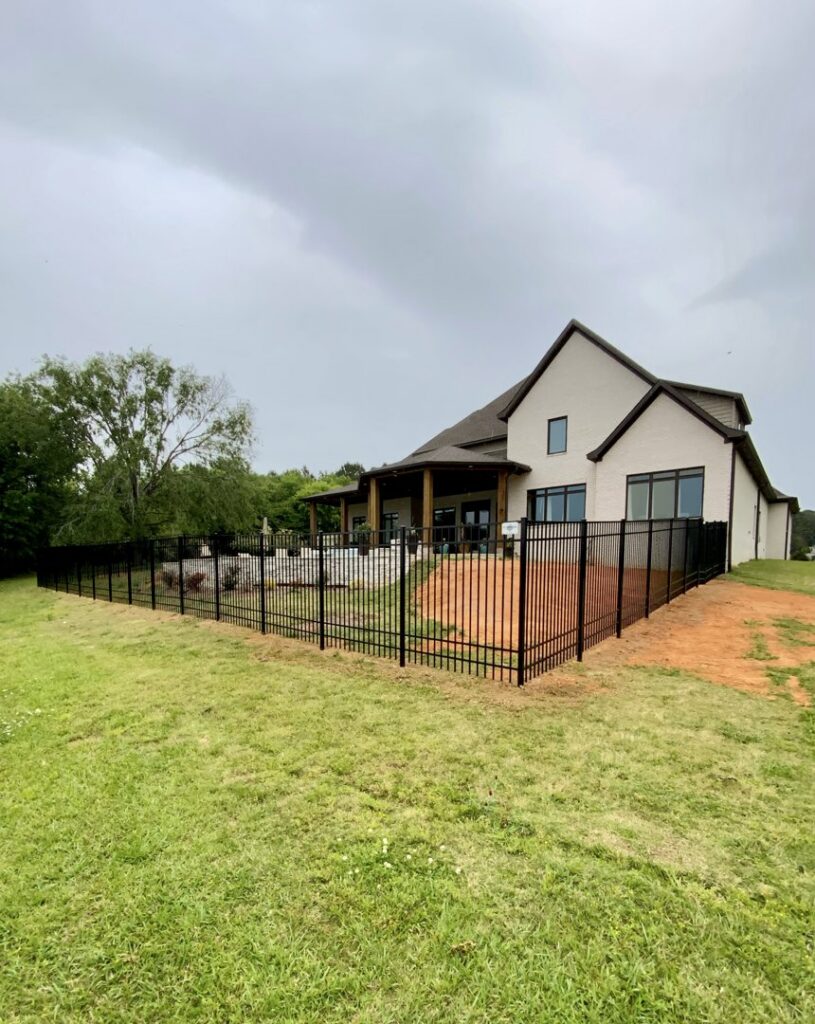 A black aluminum fence installed around a large residential property by TC Fencing LLC in Tuscaloosa, AL.