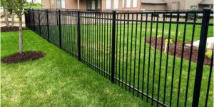A black aluminum fence installed in a residential backyard by Sumter Fence Company in South Sumter, SC.