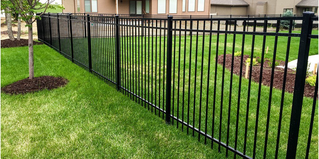 A black aluminum fence installed in a residential backyard by Sumter Fence Company in South Sumter, SC.
