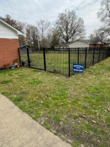 A black aluminum fence with a gate installed around a residential yard by Smithfield Fence in Crowder, MS.