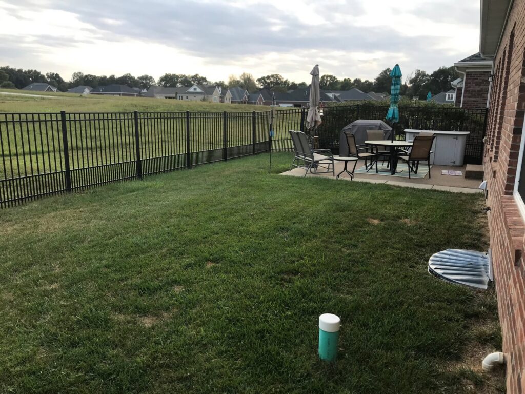 A sturdy black aluminum fence enclosing an outdoor patio area by ACE and Sons Fence Company in Evansville, IN.