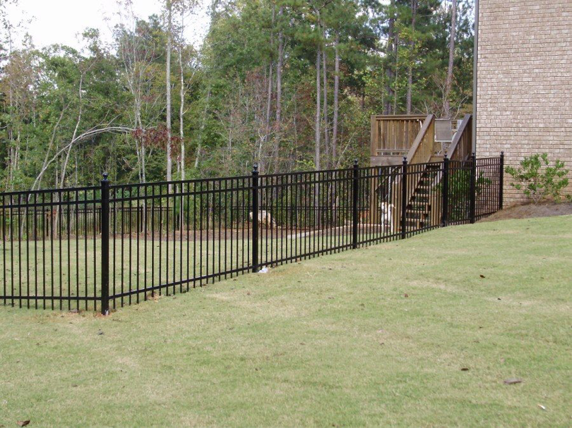 A black aluminum picket fence installed around a backyard, showcasing work by Colorado Fence and Gate Systems in Colorado Springs, CO.