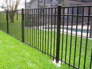 A black aluminum fence installed around a swimming pool area by Big Jerry's Fencing of Boise ID in Holly Springs, NC.